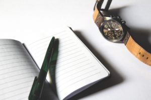 pen, paper, and watch for the job interview preparation