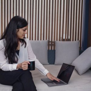 A job offer being contemplated on by a brunette woman in front of a laptop