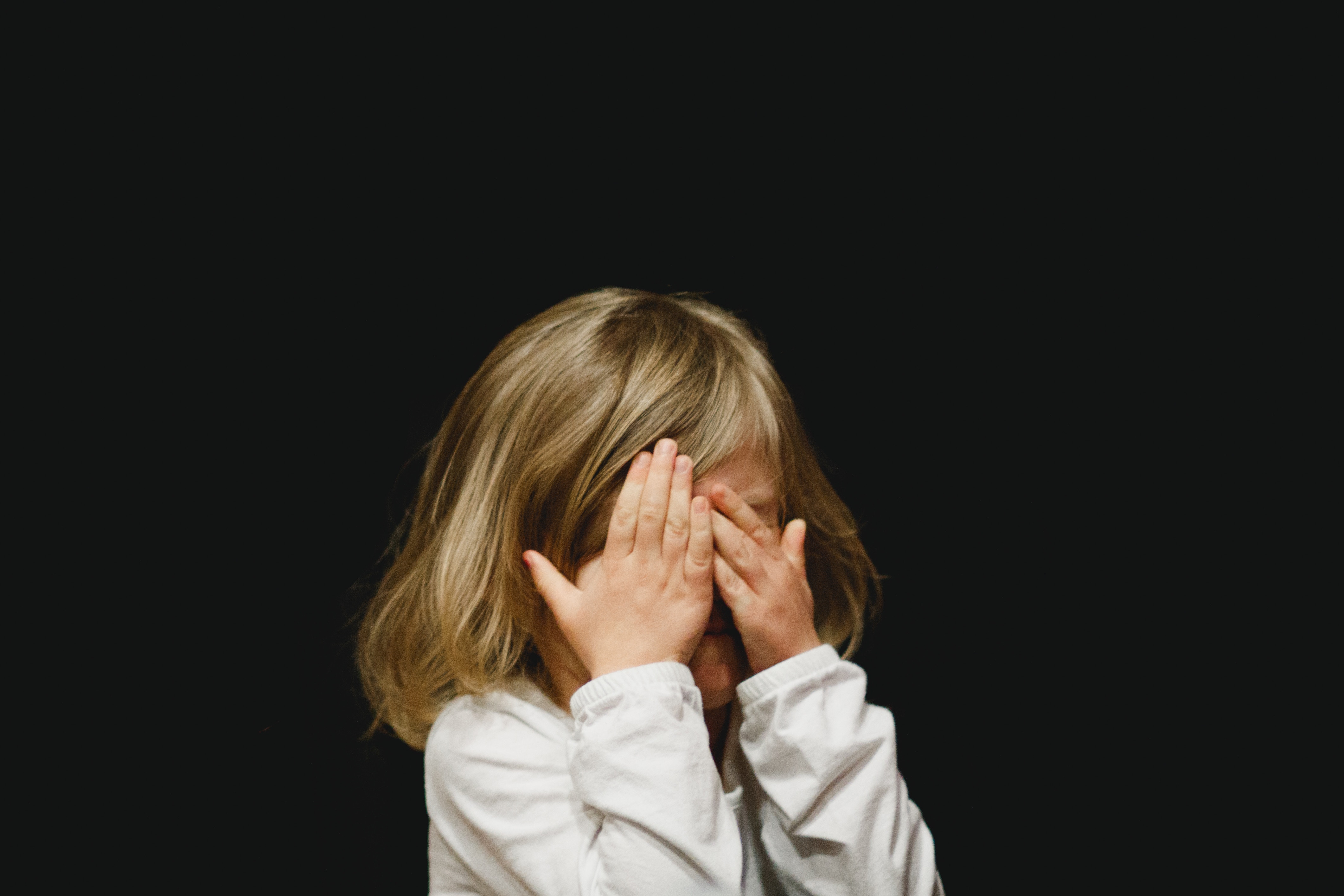 A girl covering her face to signify your resume mistakes