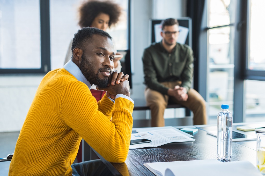 A man listening to workmate talking about workplace etiquette