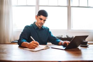 Man taking notes about resume writing