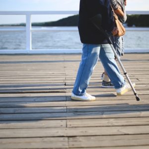 person walking with crutches who needs resume writing tips for people with disabilities