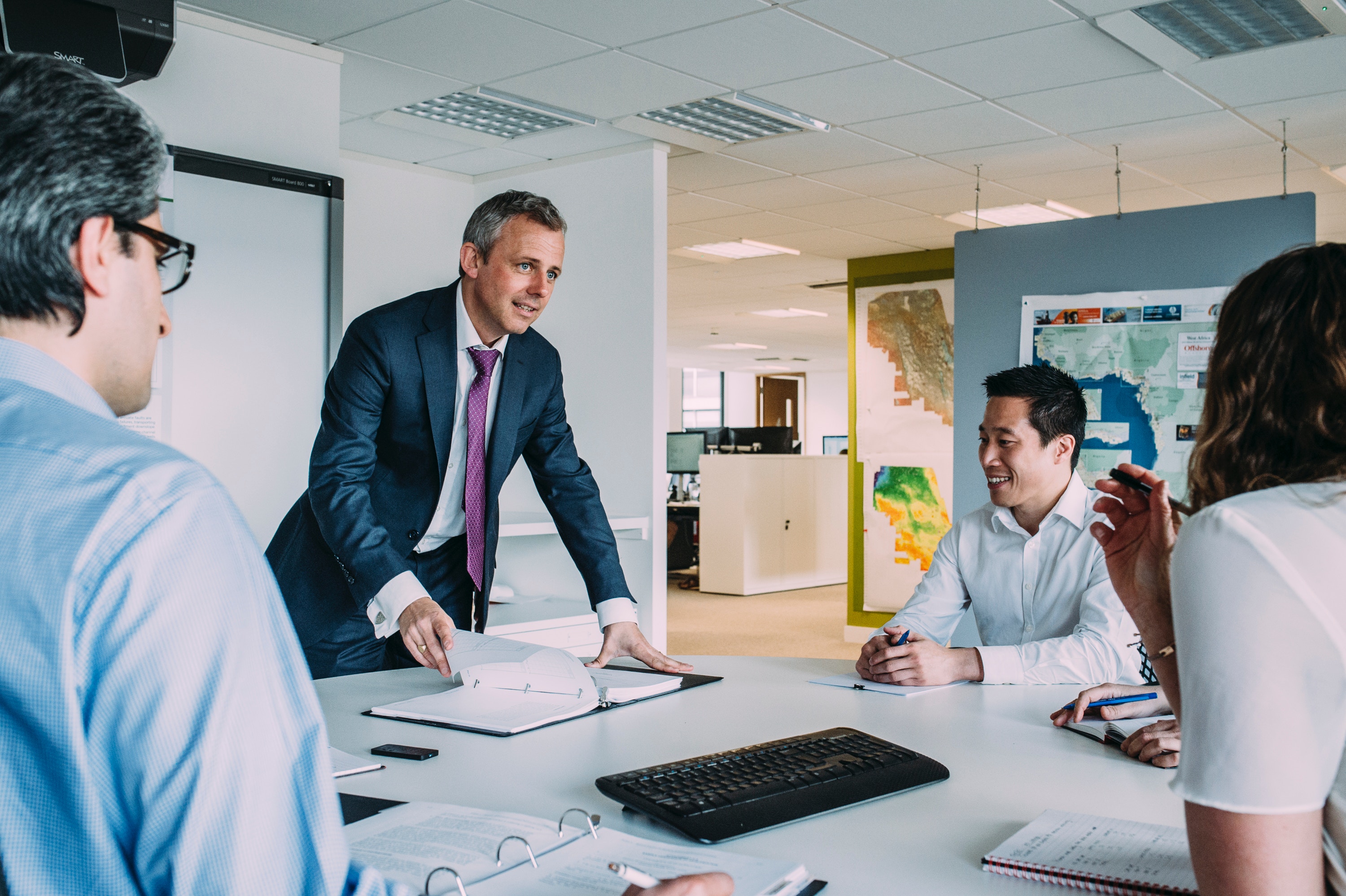 man leading a happy meeting with team members