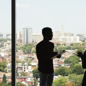 Silhouette of man and woman in the office talking about how to spot the right recruiter