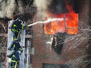 Firefighters extinguishing fire as an example of terrifying jobs