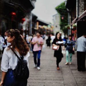 Woman walking in the streets of Hong Kong looking for industries for skilled foreign workers