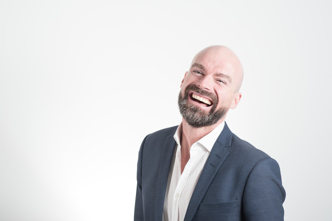 A smiling man wearing suit ready to go to his dream jobs