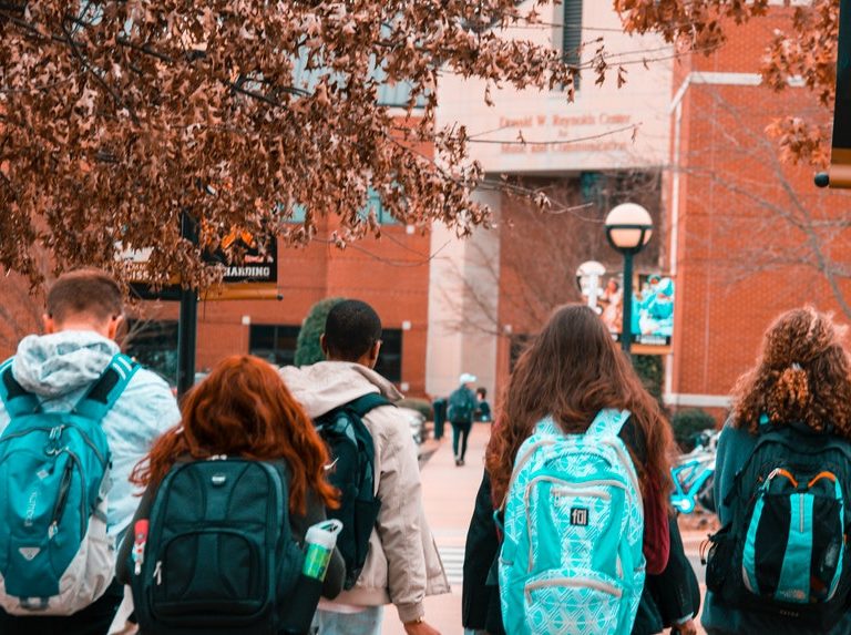 A group of college students carrying their backpacks to prepare for their future job