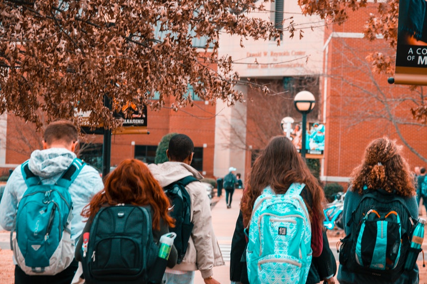 A group of college students carrying their backpacks to prepare for their future job