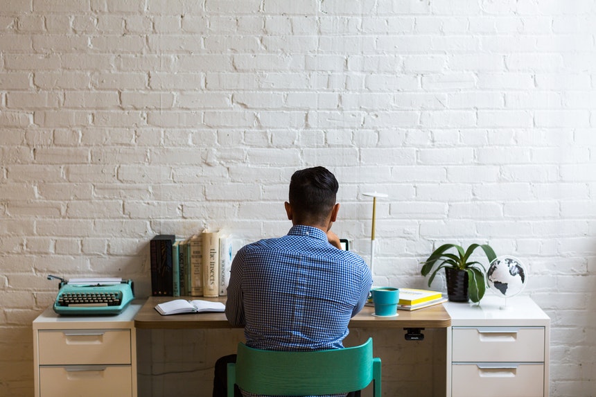 back view of male professional resume writer at work