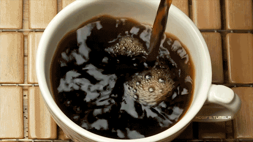 An employee pouring black coffee into a white mug 