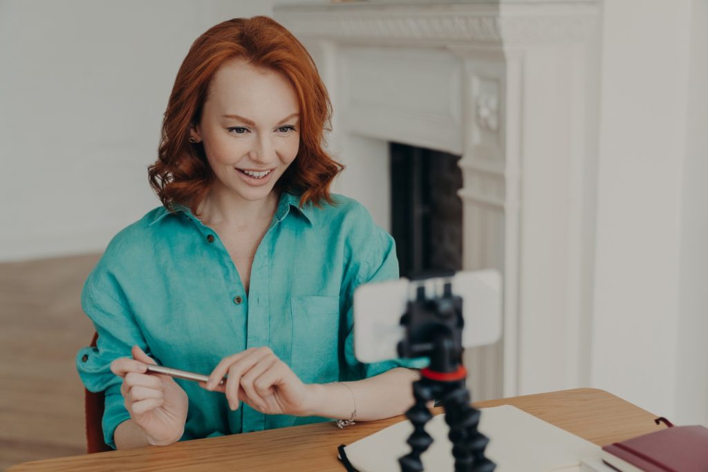 a woman smiling and showing confidence while shooting her video resume
