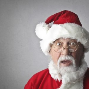 An old beard man dressed like santa claus shocked about holiday job search