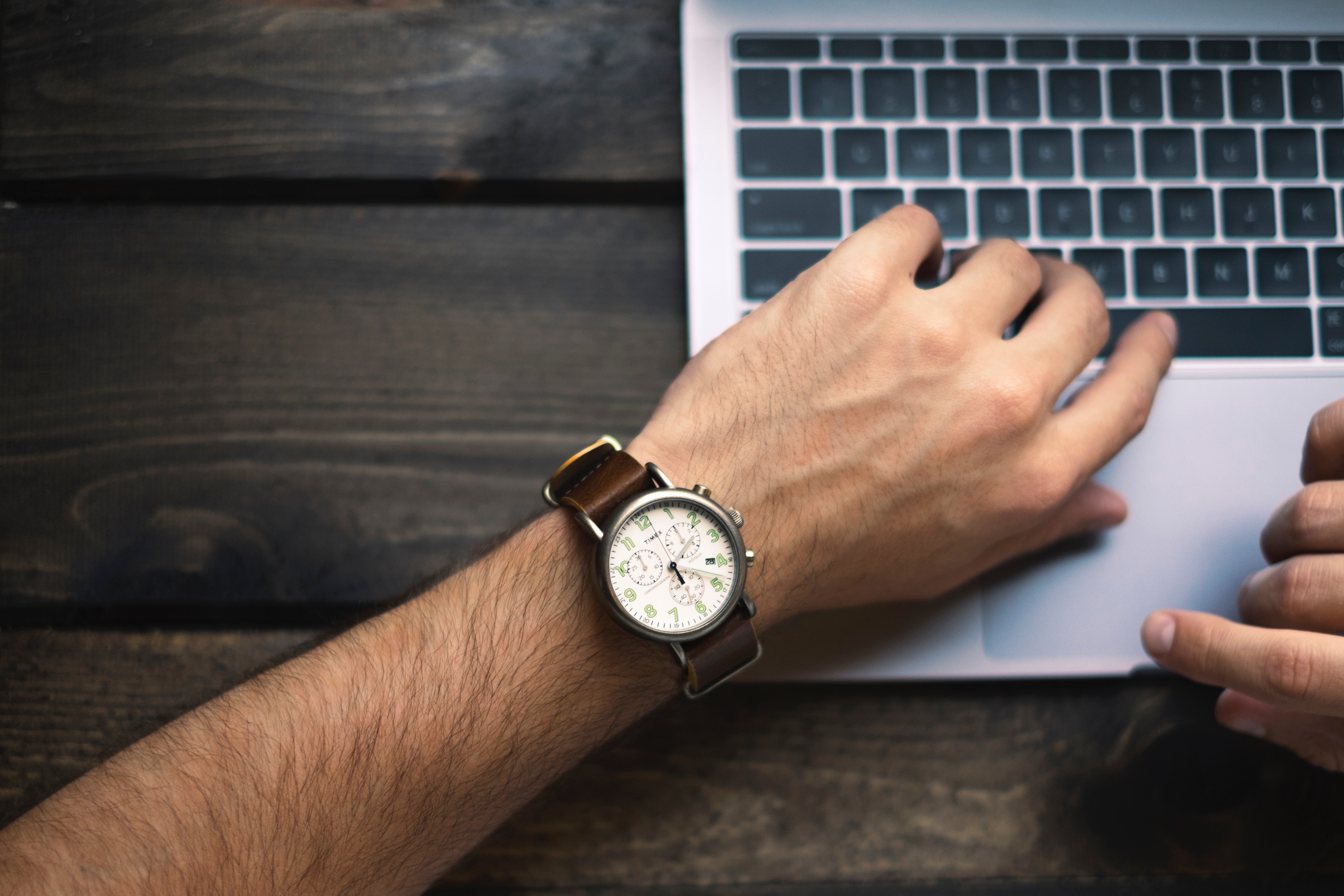 a man with a watch and a laptop that helps you be productive
