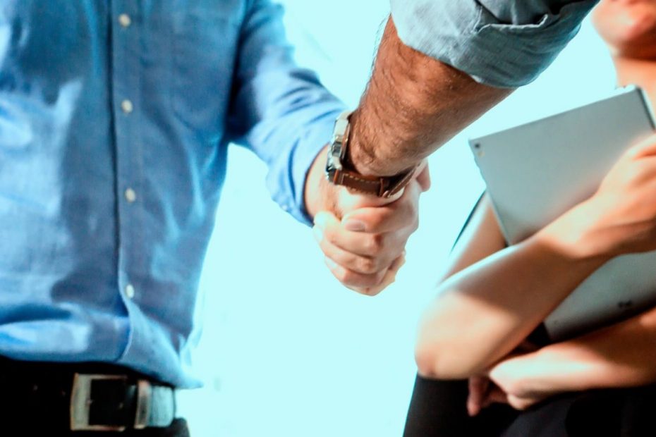 man shakes hand of colleague for the new job