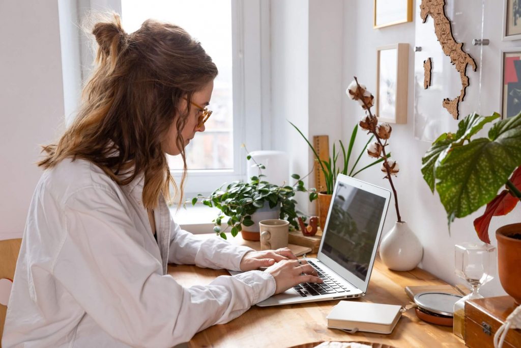 woman preparing for online job applications by updating her resume