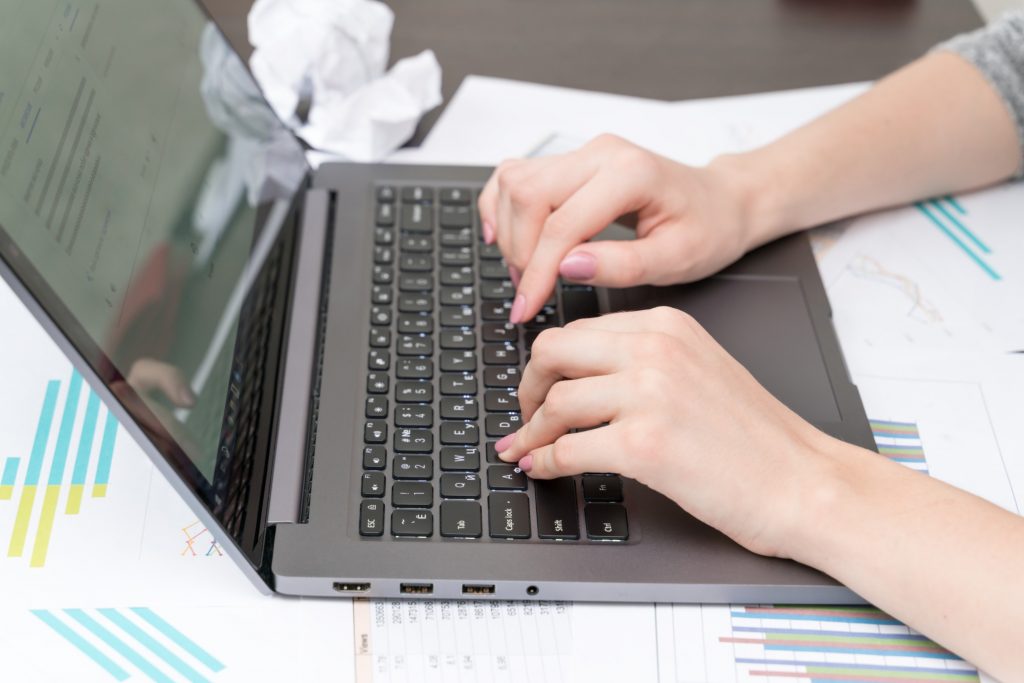 job seeker preparing her resume on her laptop