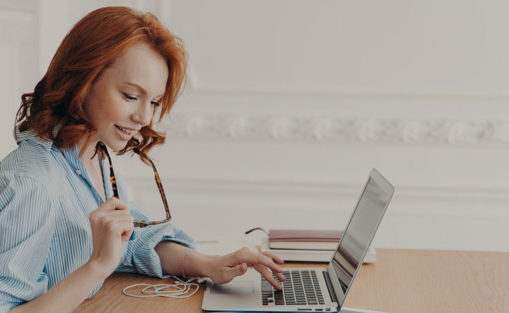 woman typing her resume on her laptop