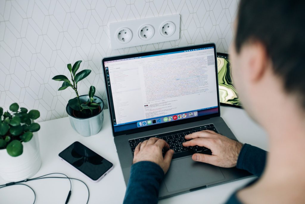 A guy encoding on his laptop as a soft skill for his resume.