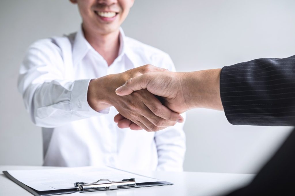 employee shake hands with employer after successful job interview