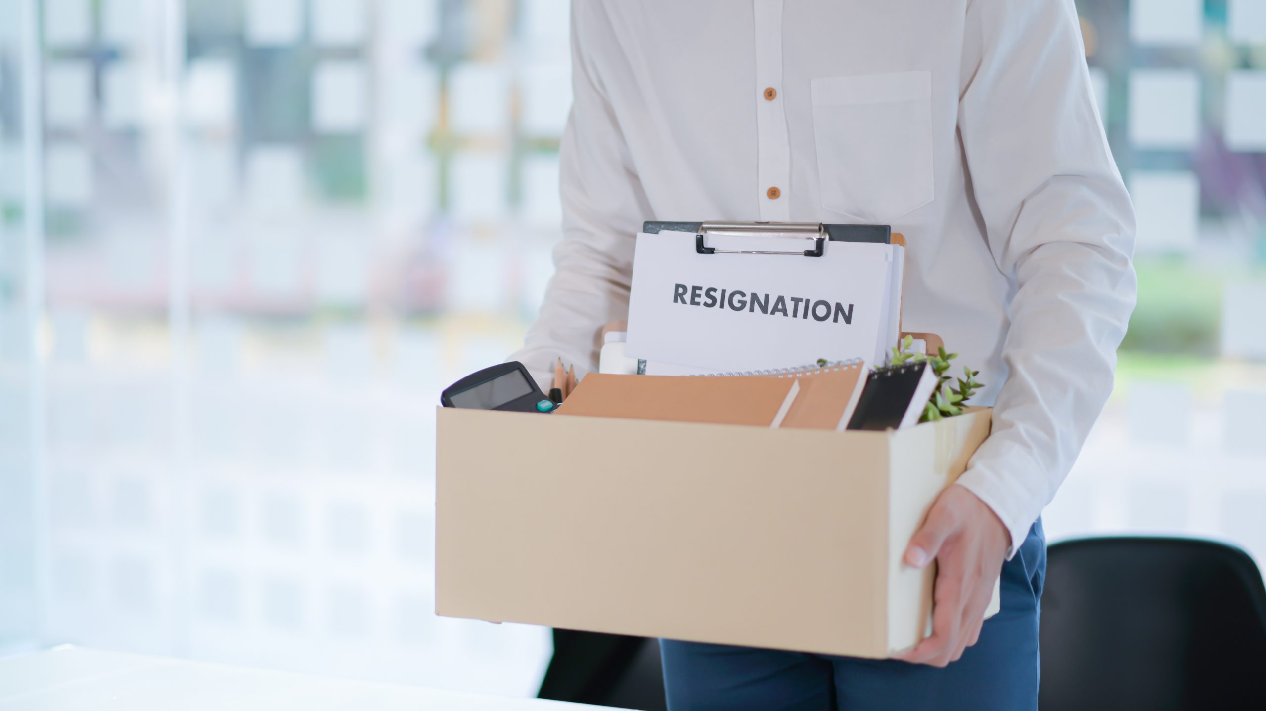 the office worker is packing things after resignation