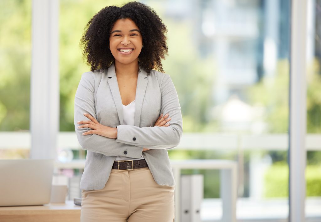 a professional smiling confidently while arms are crossed