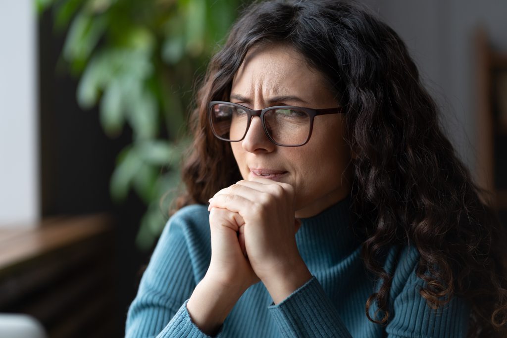 a female employee thinking on how to be more confident at work