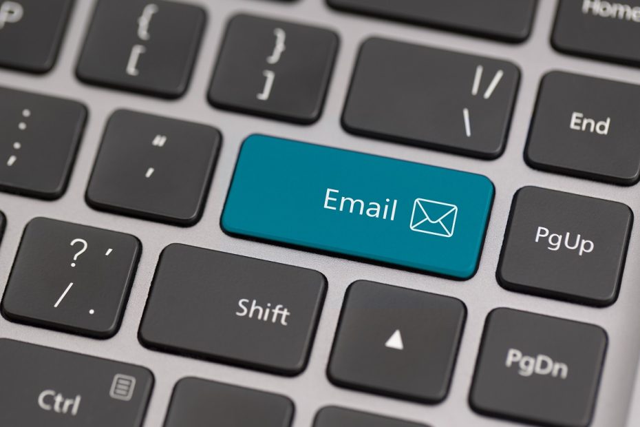 a laptop keyboard displaying an email icon