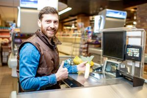 Happy cashier at the cash register